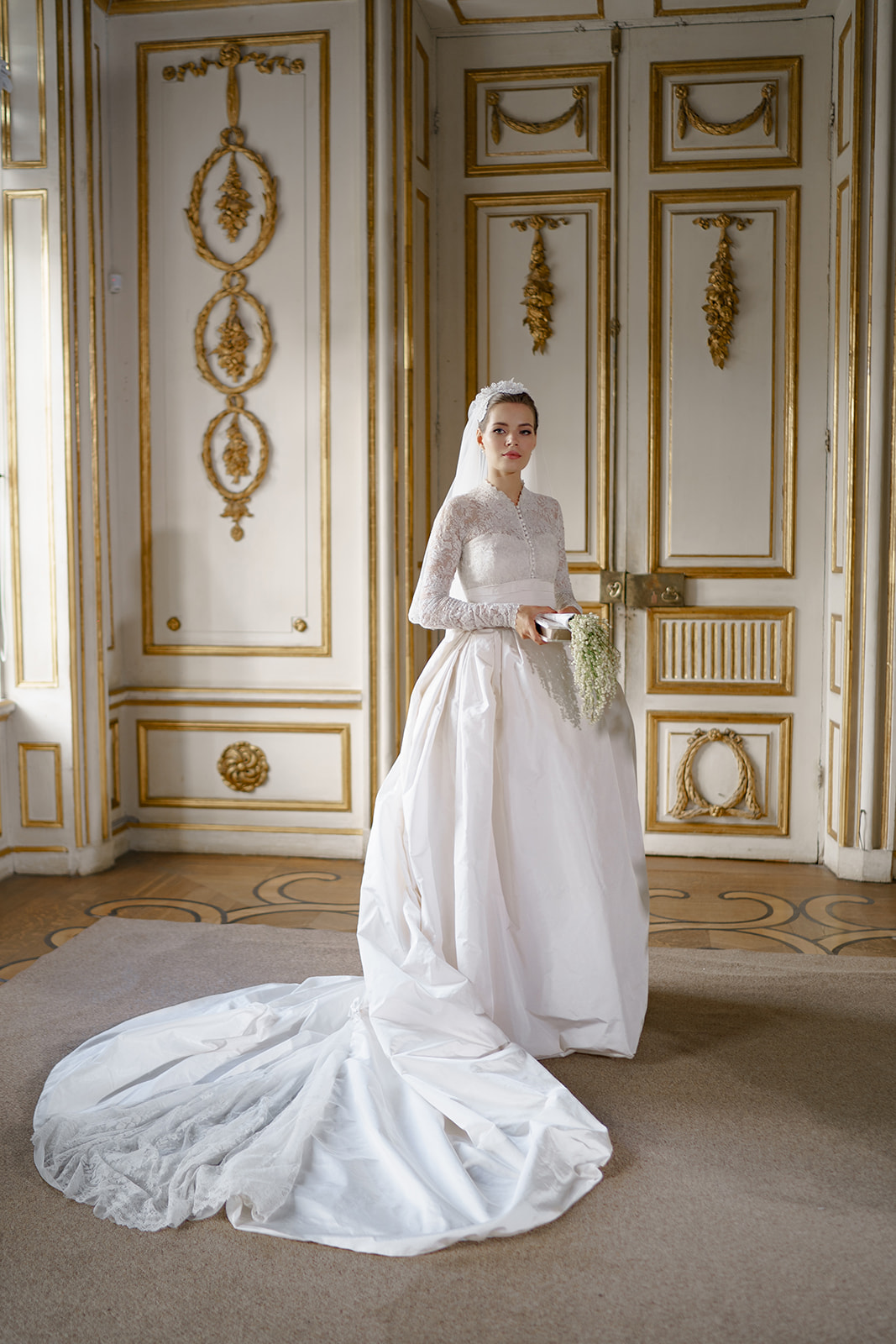 bride poses in her Grace Kelly replica wedding gown